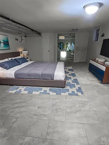 a bedroom with a bed and window