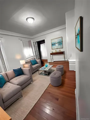 a living room with furniture and a lamp