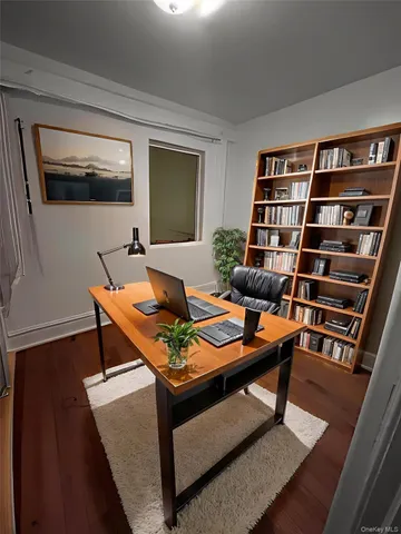 a living room with furniture a rug and a bookshelf