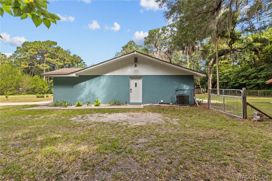 107 Allen Avenue Inglis, FL 34449 - Photo 30 of 36 a house with trees in the background