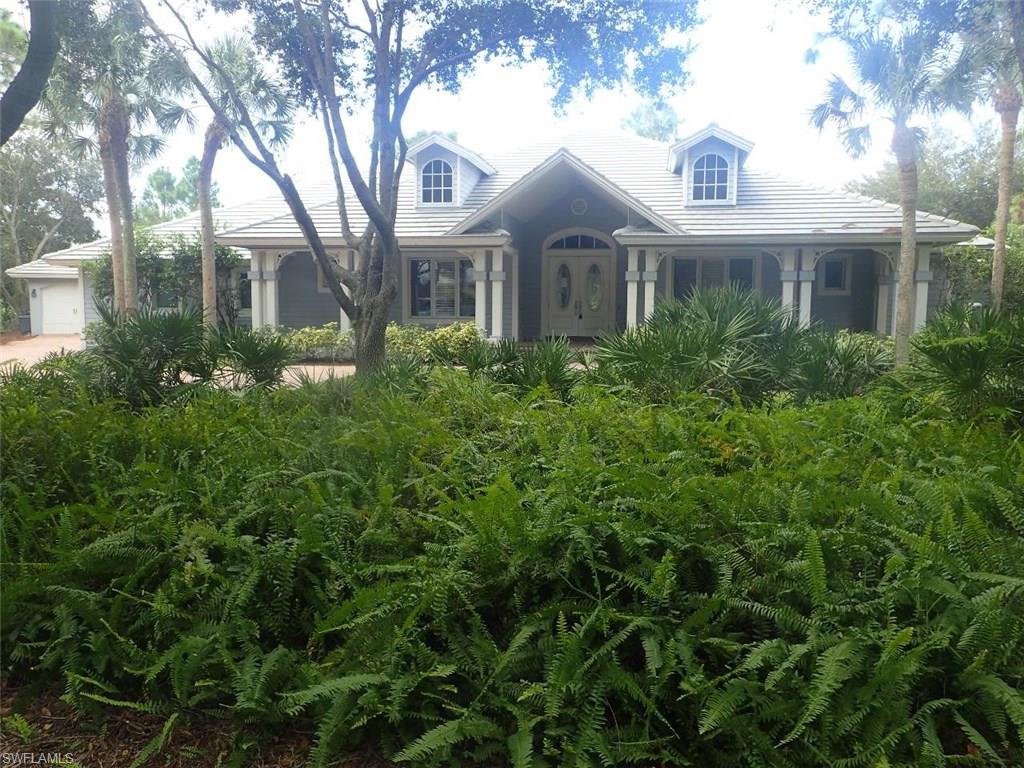 a front view of a house with yard and green space