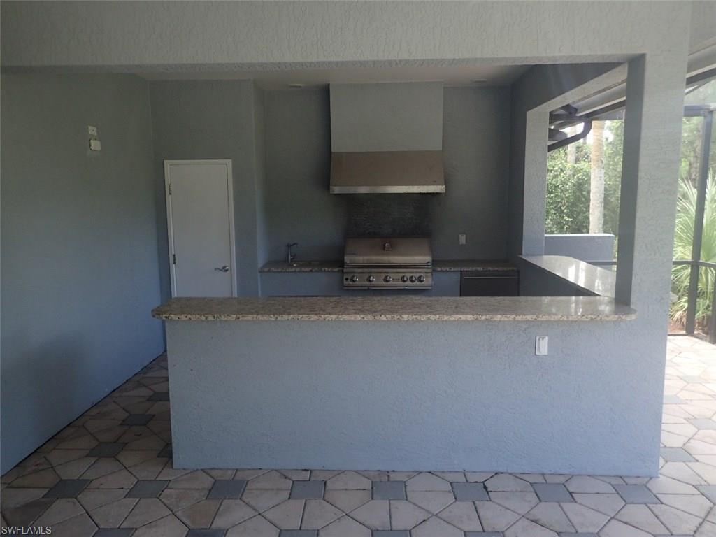 11623 Useppa Court Naples, FL 34110 - Photo 4 of 9 a living room with a couch