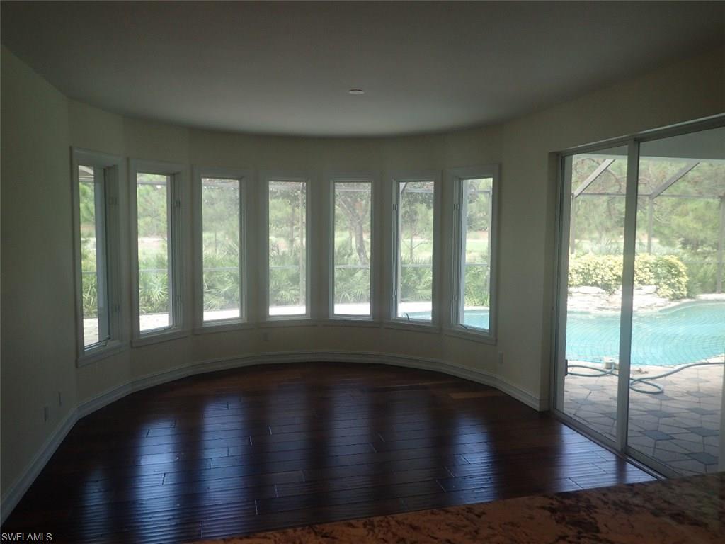 11623 Useppa Court Naples, FL 34110 - Photo 6 of 9 a view of wooden floor and windows in a room