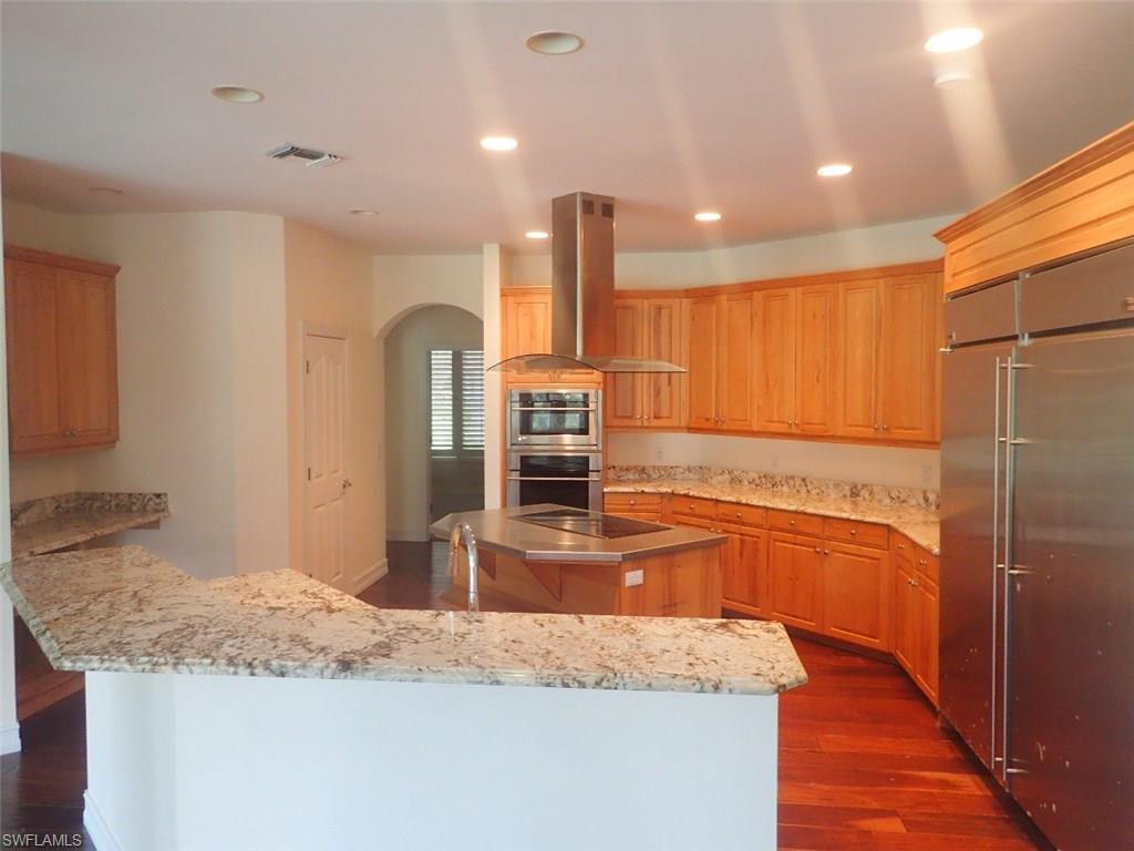 11623 Useppa Court Naples, FL 34110 - Photo 7 of 9 a kitchen with stainless steel appliances granite countertop a refrigerator and a sink