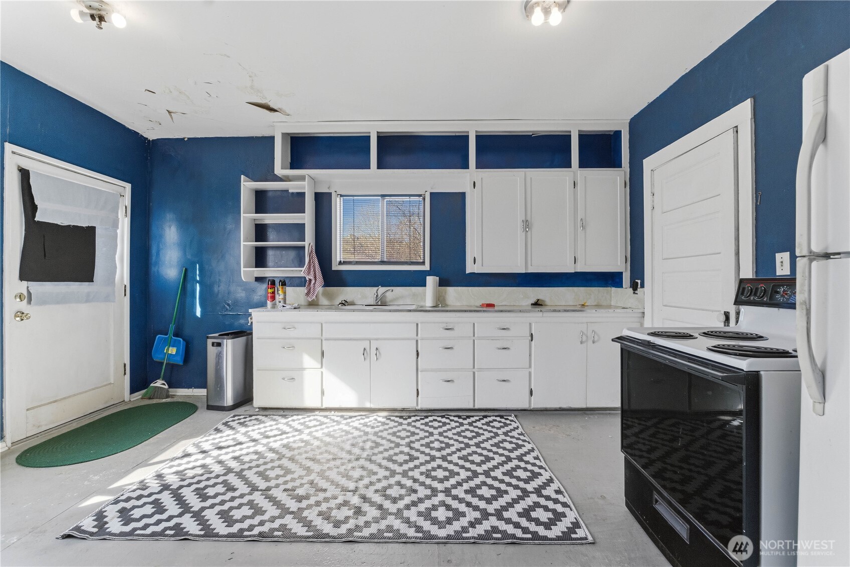 1248 South Mission Street Wenatchee, WA 98801 - Photo 6 of 22 a kitchen with stainless steel appliances granite countertop a stove a sink and a microwave