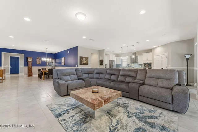 a kitchen with kitchen island granite countertop a stove a sink a dining table and chairs