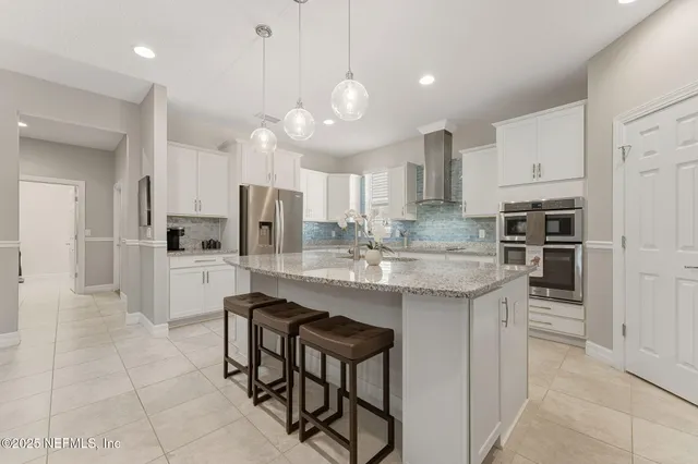 a kitchen with a sink a counter top space and living room view
