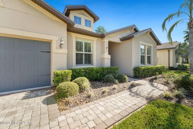 a view of a hallway with a livingroom and furniture