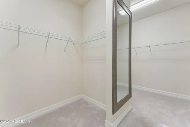 a bathroom with a granite countertop sink a light fixture and a mirror