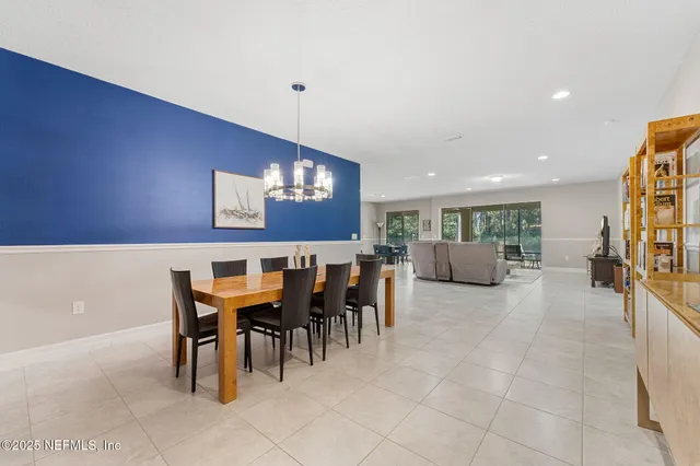 a view of a dining room with furniture and chandelier
