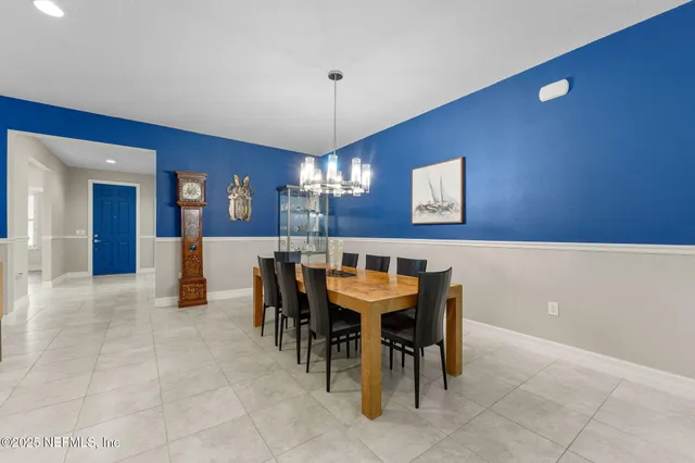 a view of a dining room with furniture and chandelier