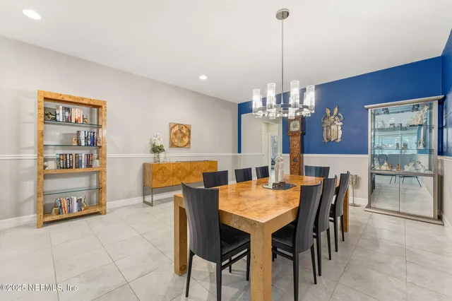 a living room with furniture and a open kitchen view
