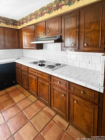 a kitchen with cabinets and appliances