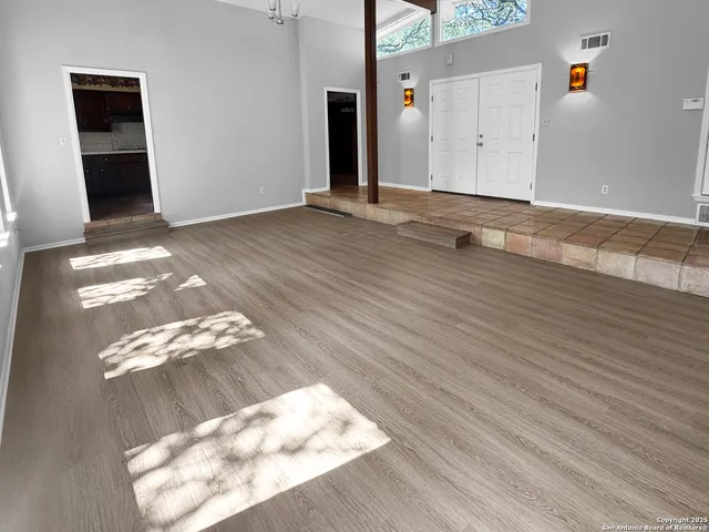 an empty room with wooden floor