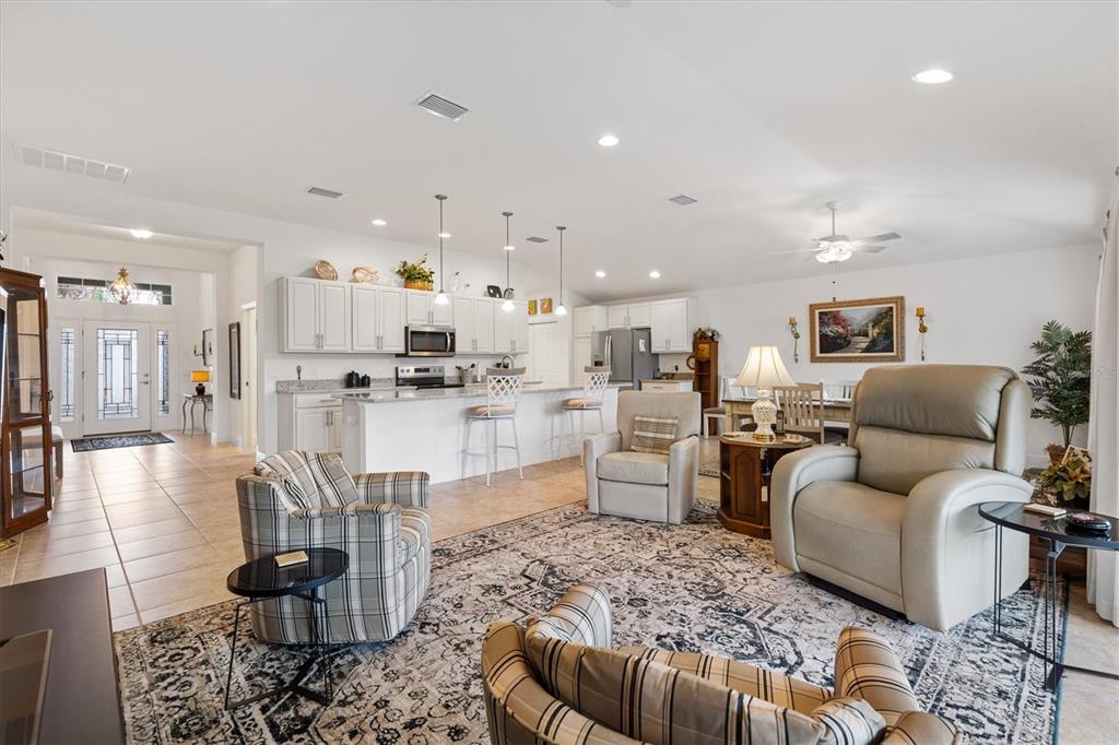10404 Silver Maple Avenue Oxford, FL 34484 - Photo 13 of 41 a living room with furniture and kitchen view