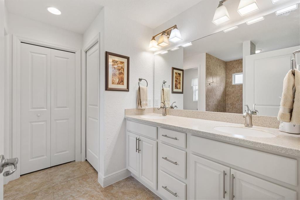 10404 Silver Maple Avenue Oxford, FL 34484 - Photo 18 of 41 a bathroom with a double vanity sink and a mirror