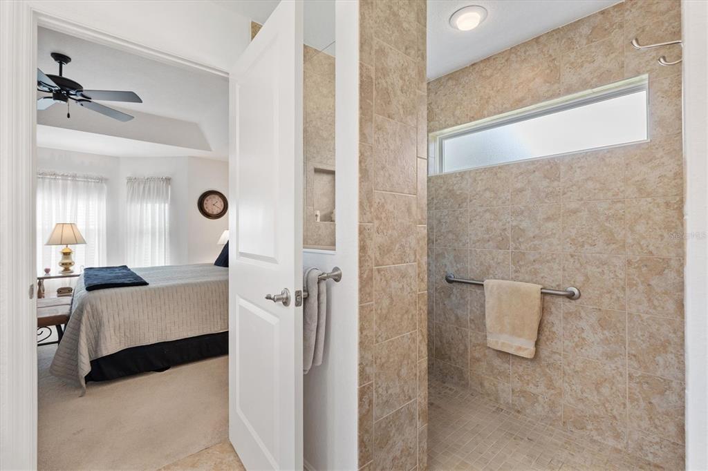 10404 Silver Maple Avenue Oxford, FL 34484 - Photo 19 of 41 a bathroom with a tub sink and mirror