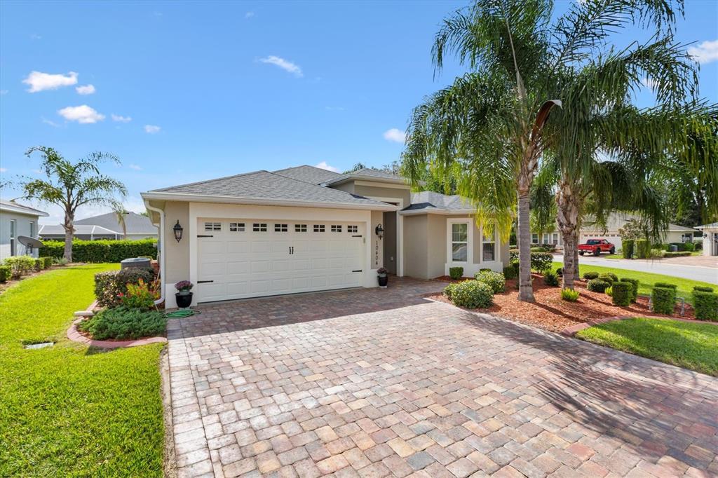 10404 Silver Maple Avenue Oxford, FL 34484 - Photo 2 of 41 a view of a house with a yard and potted plants