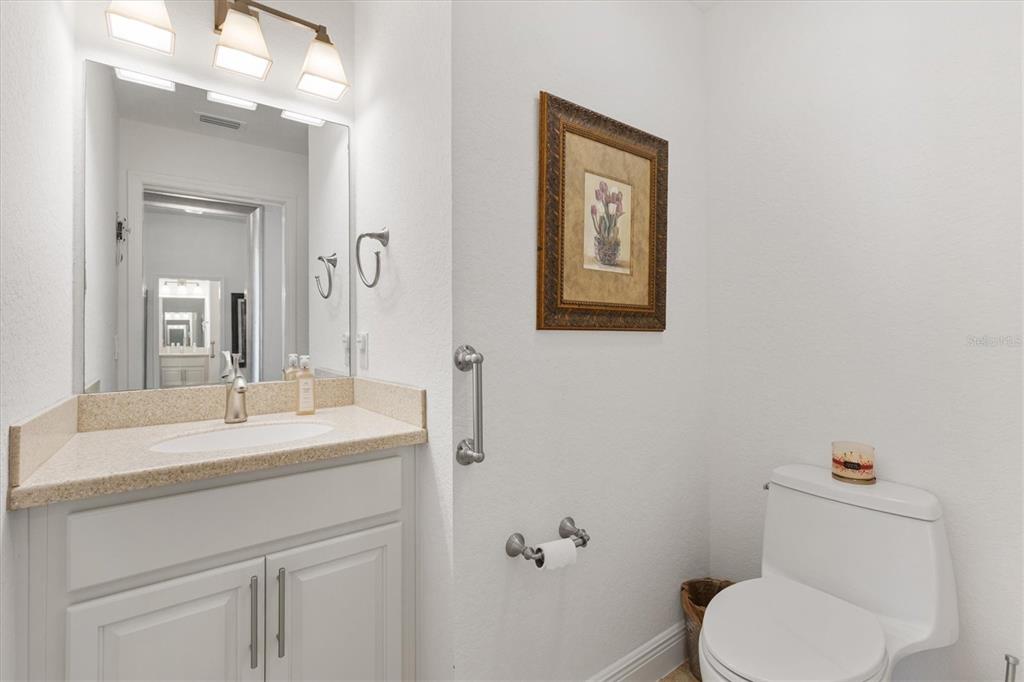 10404 Silver Maple Avenue Oxford, FL 34484 - Photo 25 of 41 a bathroom with a toilet sink vanity and mirror