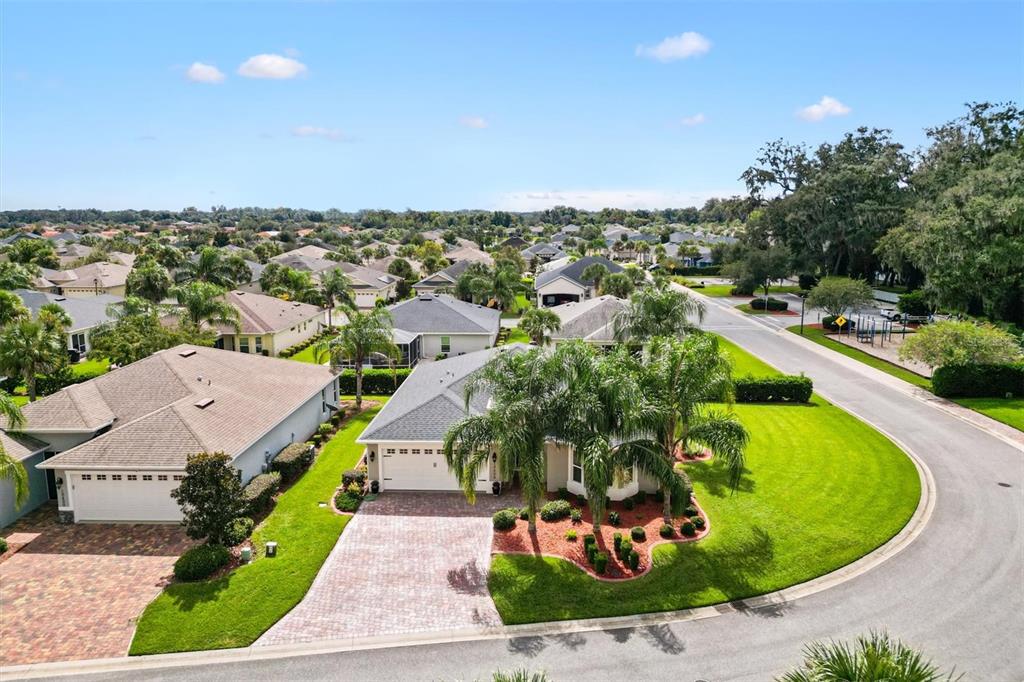 10404 Silver Maple Avenue Oxford, FL 34484 - Photo 33 of 41 an aerial view of a house with a garden and lake view