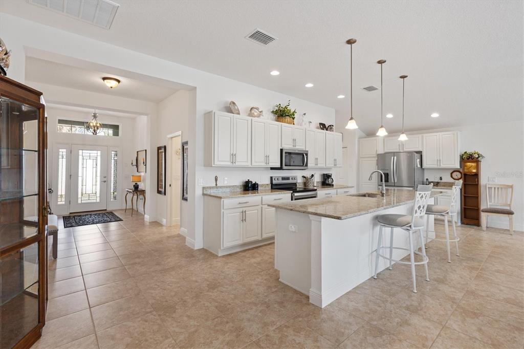 10404 Silver Maple Avenue Oxford, FL 34484 - Photo 8 of 41 a large white kitchen with lots of counter space and appliances