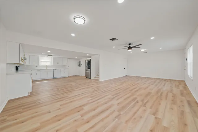 a view of a kitchen with a dishwasher cabinets and wooden floor