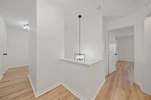 a view of a room with wooden floor