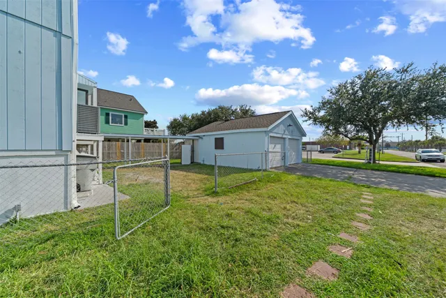 a view of a house with backyard and a tree