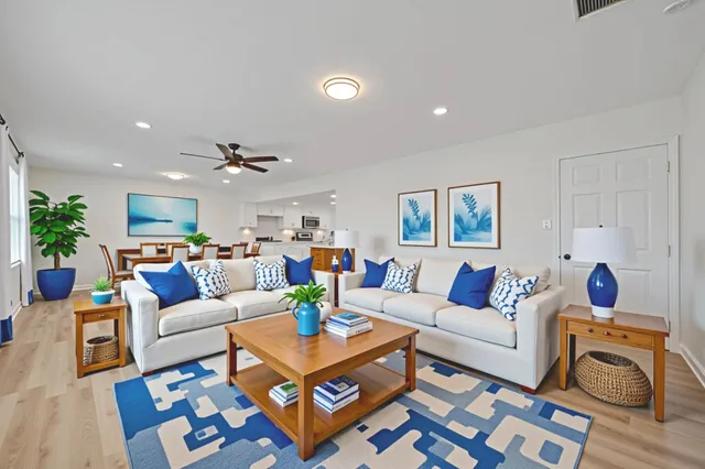 a living room with furniture and wooden floor