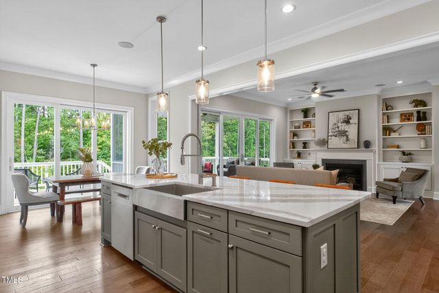 a large kitchen with stainless steel appliances granite countertop a stove a sink dishwasher and a refrigerator