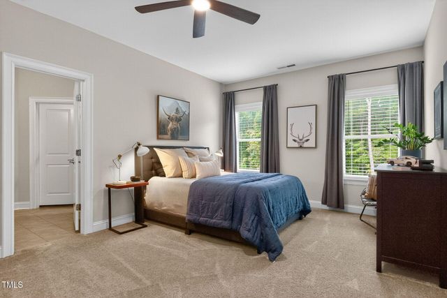 a bedroom with a bed potted plant and a window