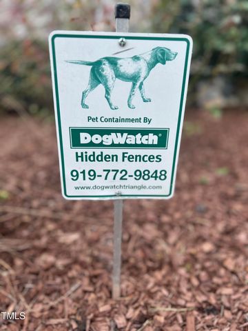 a front view of a house with a yard and potted plants