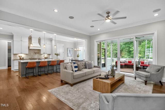 a living room with furniture fireplace and window