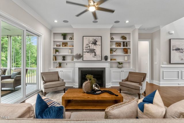 a kitchen with stainless steel appliances granite countertop a dining table chairs stove a refrigerator and cabinets