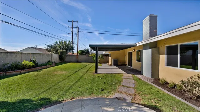 a view of a house with a small yard and plants