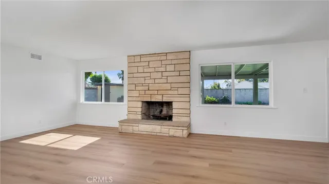a living room with a fireplace and a wooden floor