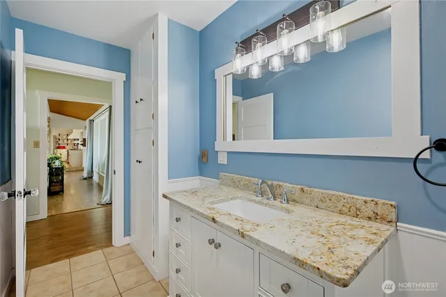 a bathroom with a sink vanity and a mirror
