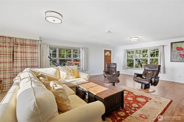 a living room with furniture window and wooden floor