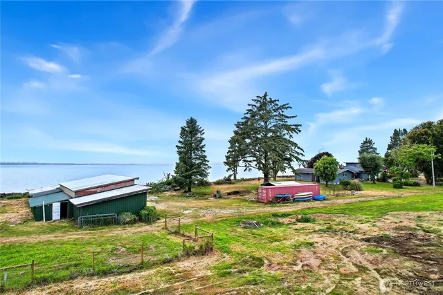 a backyard of a house with table and chairs