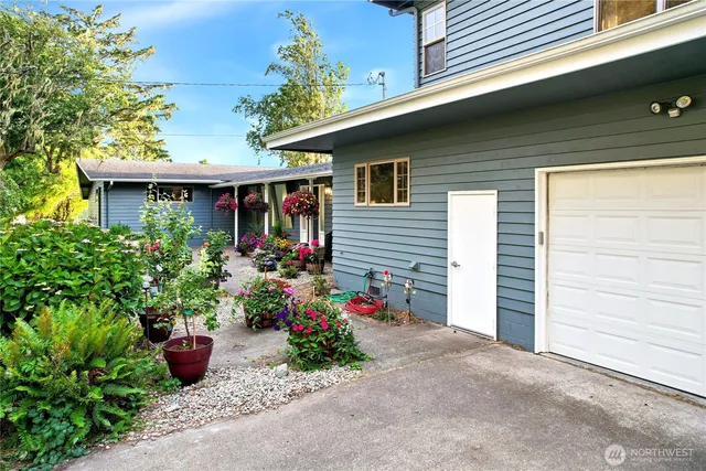a front view of a house with plants