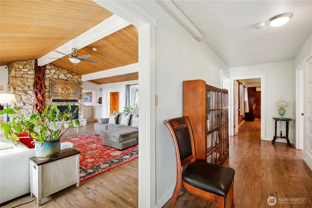 a living room with furniture fireplace and wooden floor