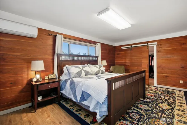 a bedroom with bed and a window