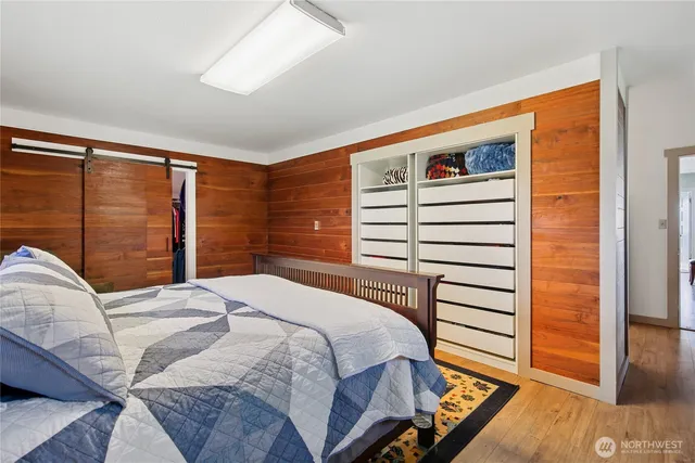 a bedroom with a bed and a large window