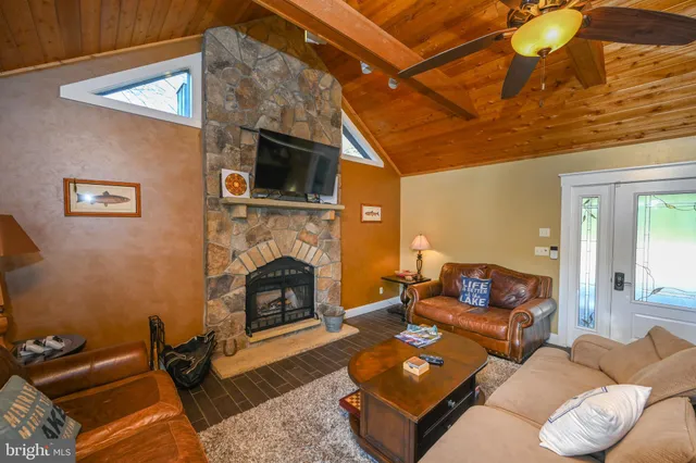 a living room with furniture mirror on wall and a fireplace