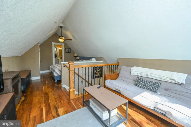 a bedroom with furniture and a wooden floor