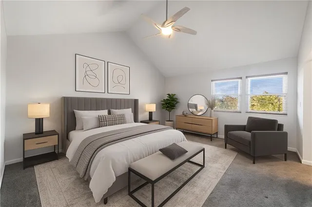 a bedroom with a bed couch and a window