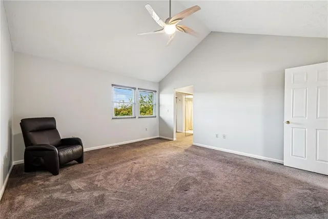 a view of a livingroom with furniture and a ceiling fan