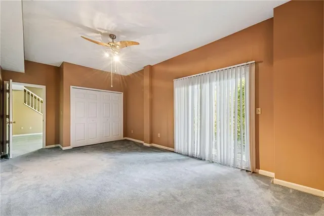 an empty room with windows and closet