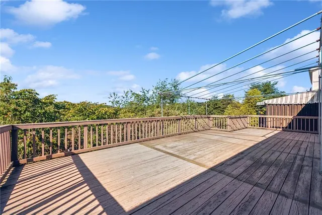 a view of balcony with wooden floor and fence