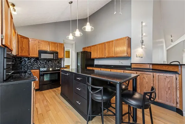 a kitchen with stainless steel appliances granite countertop a stove and a refrigerator